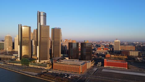 Drone-view-of-Renaissance-Center-on-the-Detroit-River-in-Downtown-Detroit-with-golden-hour-sunlight
