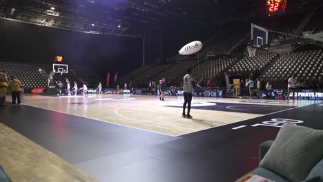 Slow-motion-shot-of-professional-female-basketball-teams-warming-up-in-a-stadium