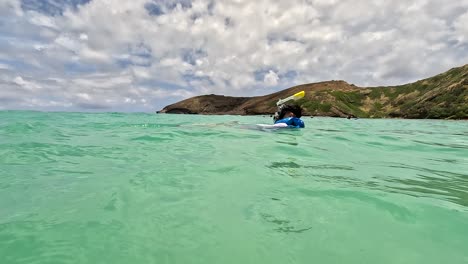 Young-Boy-Floating-Like-A-Sea-Otter-In-Hanauma-Bay,-Oahu,-Hawaii