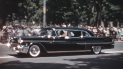 Black-Classic-Car-Drives-Through-the-Crowd-During-Military-Funeral-Procession