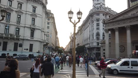 Argentine-people-cross-the-streets-at-metropolitan-cathedral,-traffic-of-south-american-capital,-panoramic-static-shot