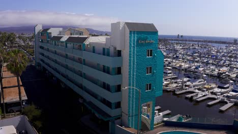 Low-panning-aerial-shot-of-the-King-Harbor-Apartments-in-Redondo-Beach,-California