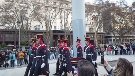 A-military-celebration,-marching-at-Argentine-central-park-landmark-with-local-families-sightseeing-the-show