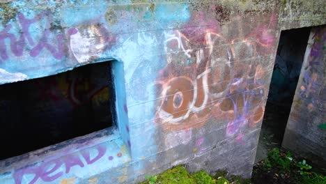 Close-up-of-entrance-to-WW2-bunkers-with-graffiti-at-The-Massey-Memorial-on-Point-Halswell-in-Wellington,-New-Zealand-Aotearoa