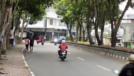 A-male-and-female-couple-are-jogging-and-walking-along-the-side-of-the-highway