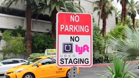 No-parking-street-sign-with-Uber-and-Lyft-logo-prohibiting-rideshare-vehicles-from-staging-on-the-street-in-Las-Vegas