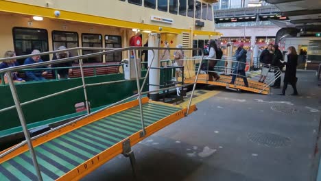 A-line-of-passengers-boarding-a-Sydney-ferry-at-Circular-Quay-in-the-early-evening