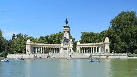 Beautiful-Monument-to-Alfonso-XII,-Madrid,-Tourists-in-Boats-in-Park