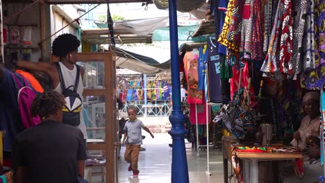 Kid-and-Vendors-on-Local-Marketplace,-Mindelo,-Cape-Verde,-Slow-Motion