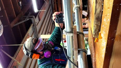 The-Carpenter-makes-Beautiful-Furniture-with-Power-Tools-to-Sand-the-Wood-Table-wearing-a-Dust-Mask-and-Safety-Goggles