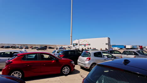 Couple-of-cars-are-waiting-to-enter-the-ferry-at-the-port-of-Zakynthos-on-a-cloudless-sunny-hot-day,-slow-motion