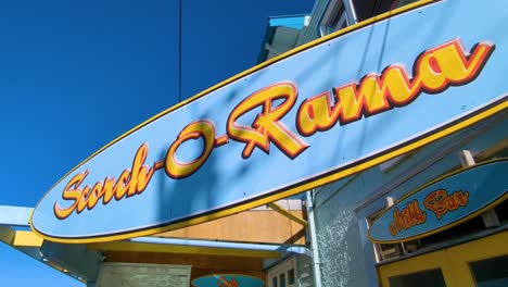 Close-up-of-sign-for-popular-seaside-cafe-Scorch-O-Rama-in-Karaka-Bay-near-Seatoun-in-Wellington,-New-Zealand-Aotearoa