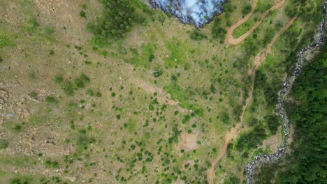 Overhead-view-of-wildfire-burning-along-the-ravine-on-the-side-of-the-mountain