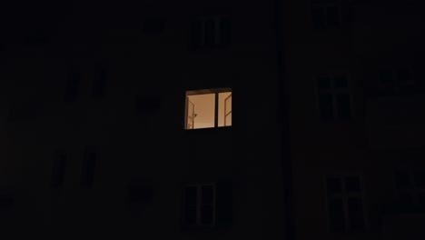 Window-at-Night-with-Warm-Light,-Handheld