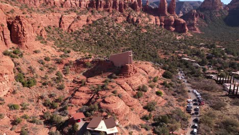 Drone-Shot,-Chapel-of-Holy-Cross-Under-Red-Rock-Sandstone-Formations-of-Sedona,-Arizona-USA