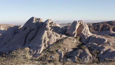 A-scenic-overview-of-the-Mojave-Desert,-showcasing-the-breathtaking-rock-formations-and-the-golden-light-of-sunrise