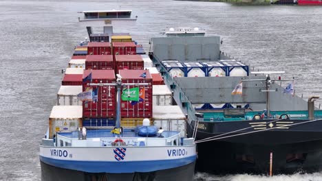 The-Container-Ship-Vrido-is-Traveling-Through-the-River-in-Alblasserdam,-South-Holland,-Netherlands---Close-Up