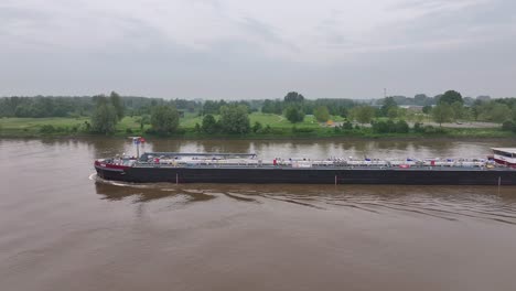 Container-vessel-NOA-glides-across-water,-fortress-of-commerce,-aerial