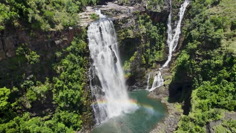 Stunning-aerial-view-of-Lisbon-Falls-cascading-into-a-serene-pool-in-lush-South-Africa