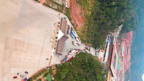 Vertical-aerial-shot-over-cargo-trucks-in-the-Boten-Special-Economic-Zone,-Laos