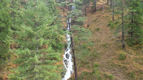 Aerial-view-of-the-waterfall-trails-in-Garmisch-Partenkirchen-during-autumn-showcases-the-vibrant-display-of-colorful-foliage