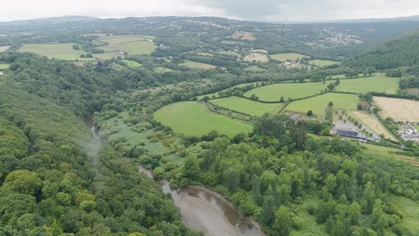 Aerial-perspective-of-the-river-Tamar-as-it-carves-its-way-through-Devon-and-Cornwall,-showcasing-the-verdant-landscapes-and-serene-waterway