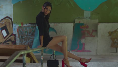 A-young-Latina-in-red-heels-at-a-warehouse-skate-park