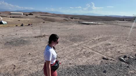 Young-female-traveller-in-Agafay-desert,-Morocco-holiday-travel-solo