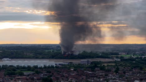 Derelict-building-fire-smoke-ash-cloud-aerial-view-across-Cheshunt-Hertfordshire-countryside