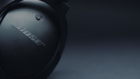 Detail-of-black-headphones-BOSE-on-a-pure-gray-background