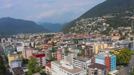 Aerial-forward-shot-of-Locarno-cityscape-with-green-hills-in-the-background-Switzerland