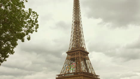 Tilt-shot-Eiffel-tower-decorated-for-the-2024-Summer-Olympics,-Paris,-France