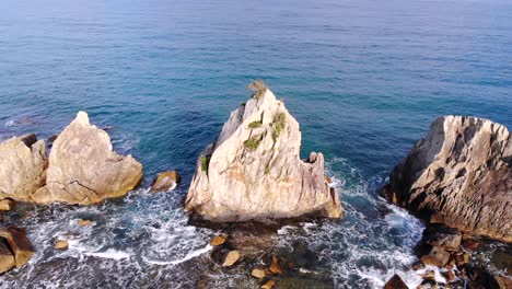 Drone-dolly-out-shot-starting-from-the-central-rock-of-Hashigui-Iwa-in-Wakayama,-Japan,-revealing-the-entire-formation