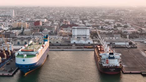 Drone-shot-of-big-cargo-ships-at-sunrise