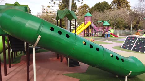 Urban-park-and-colorful-playground-kids-games-at-Buenos-Aires-City-Argentina,-families-play-in-outdoors-plaza-environment