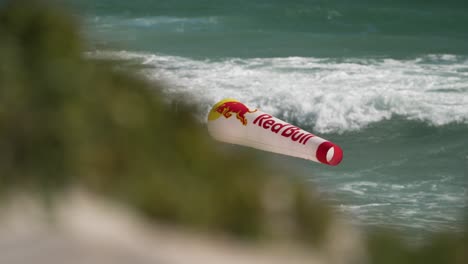 Red-Bull-windsock-flapping-in-wind-at-KOTA-kiteboarding-event,-Bloubergstrand