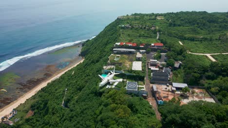 Uluwatu-Nyang-Nyang-Beach-with-plane-jet-hotel-at-the-cliff-in-Bali,-Indonesia