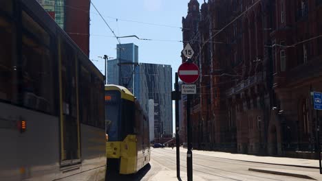 Metrolink-Tram-Passes-By-On-Street-In-Manchester-at-Golden-Hour,-static-shot