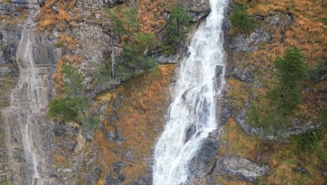 Aerial-view-of-the-waterfall-trails-in-Garmisch-Partenkirchen-during-autumn-showcases-the-vibrant-display-of-colorful-foliage