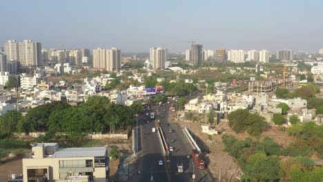 aerial-drone-view-moving-towards-road-with-lots-of-traffic-and-houses-around