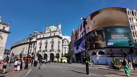 A-vibrant-view-of-Piccadilly-Circus-in-London,-showcasing-digital-billboards-and-historical-architecture-on-a-sunny-morning