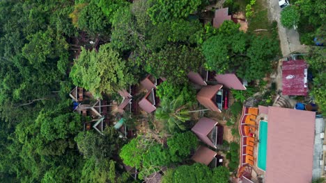 VERTICAL,-Tiered-Hillside-Bungalows-And-Chalets-Amid-Green-Nature,-Drone-View