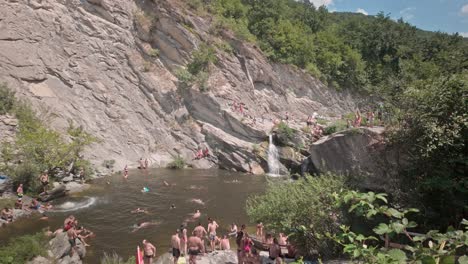 Bathing-Crowds-enjoy-Hot-Summer-fun-cool-off-swimming-in-mountain-river