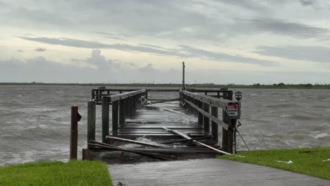 The-storm-surge-from-Hurricane-Baryl-ravages-a-boat-dock-on-Galveston-Bay,-causing-severe-damage-and-upheaval