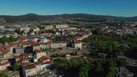 Aerial-view-of-Barcelos-city-center-showcasing-Senhor-da-Cruz-Church,-Portugal