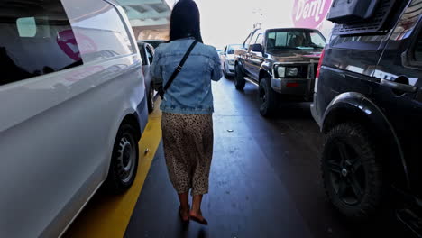 Behind-woman-traveller-walking-out-of-ferry-in-the-Port-of-Zakynthos,-Greece