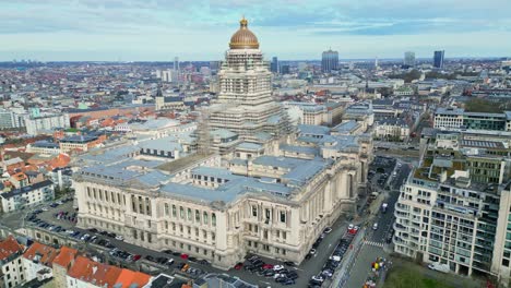 Aerial-drone-view-pan-left-Palace-of-Justice-in-Brussels,-Belgium,-historical-city,-on-a-beautiful-summer-with-cloudy-sky