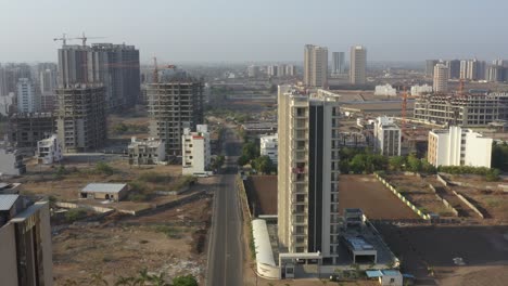 A-big-road-is-visible,-many-vehicles-moving-and-high-rise-buildings-are-visible