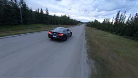 A-Ford-Bullitt-Mustang-driving-in-the-backcountry-on-a-remote-road