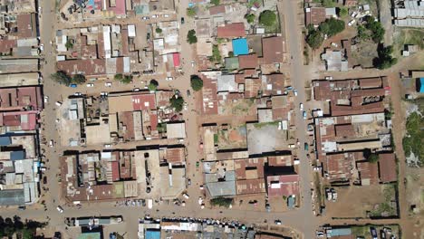 Poor-rusty-buildings-in-African-town,-Loitokitok-in-Southern-Kenya,-aerial-top-down